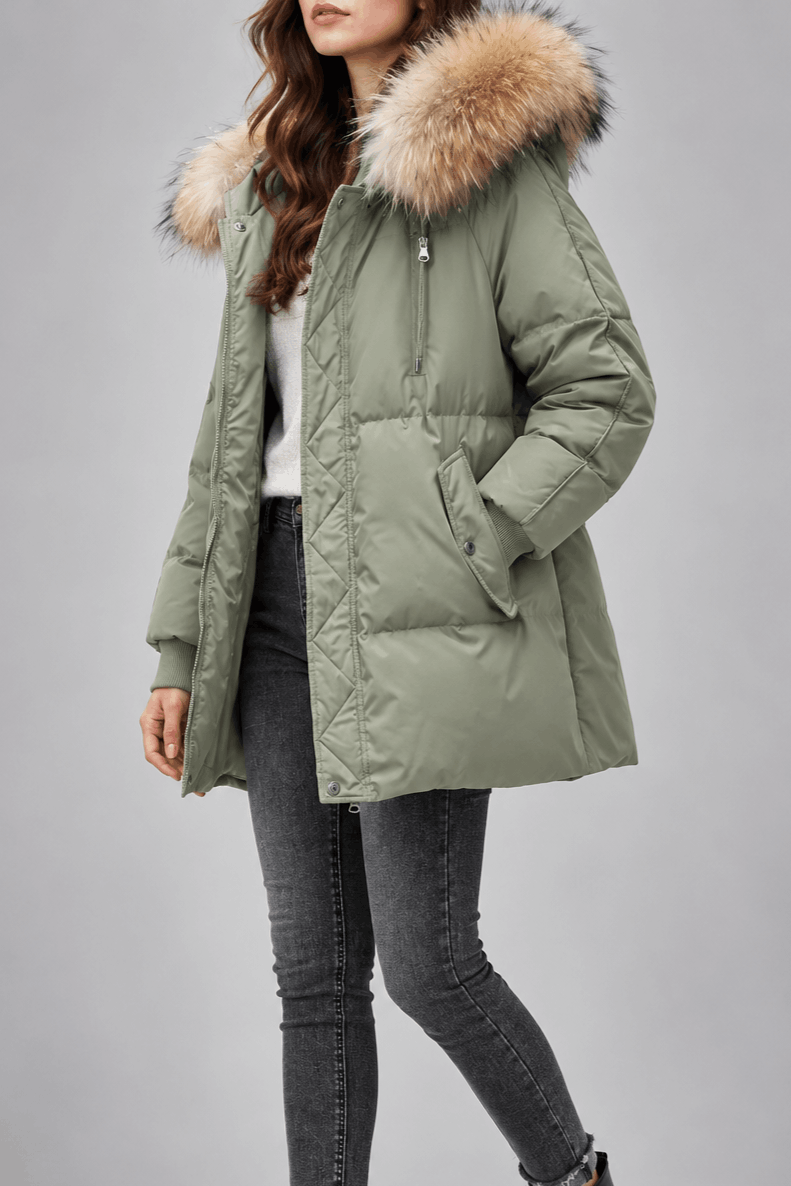 Sage green oversized puffer jacket with plush-trim hood, quilted snap placket, and ribbed knit cuffs.