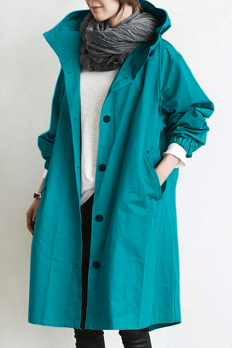 Teal oversized hooded trench coat in lightweight fabric with a button-front placket and slant hip pockets.