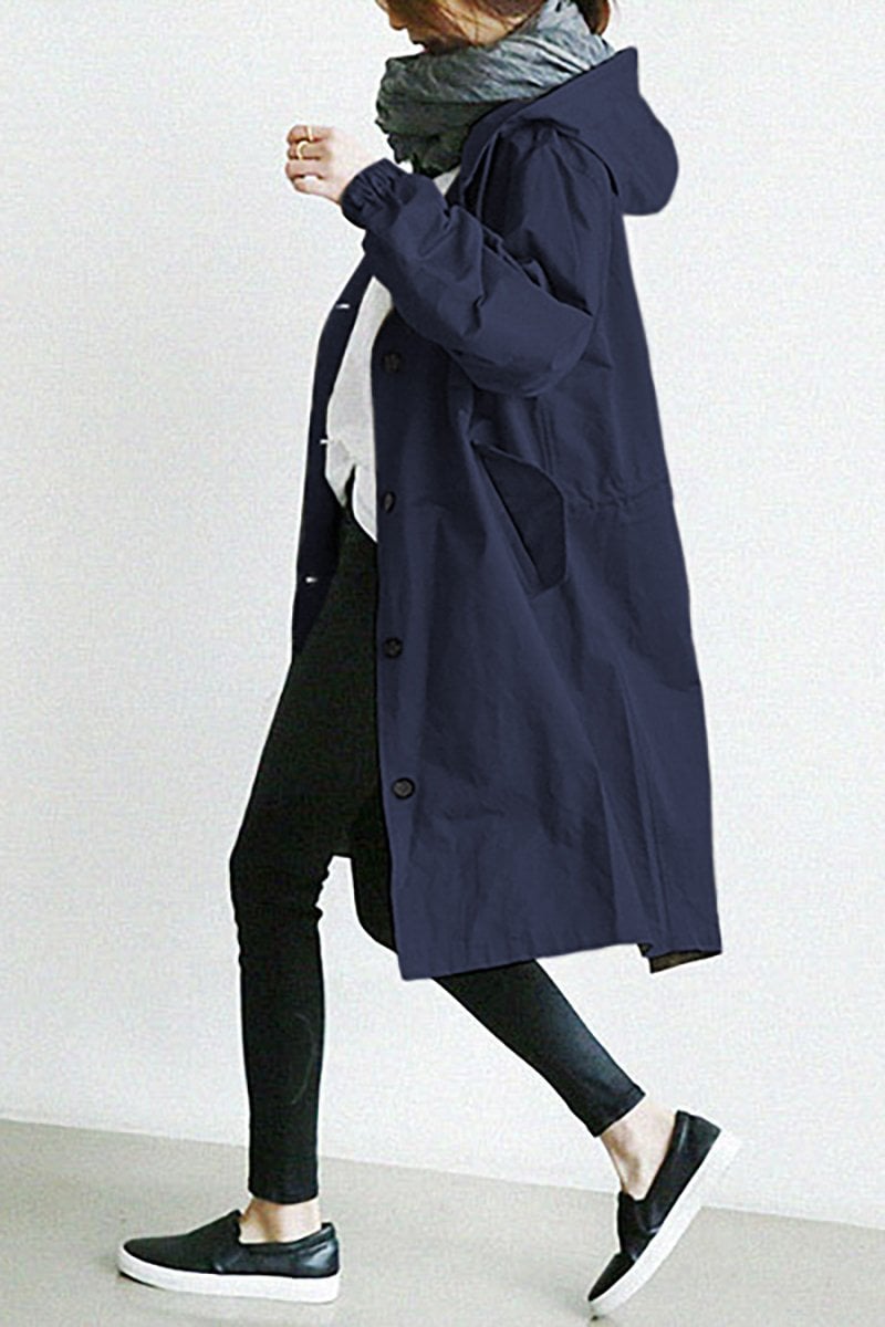 Oversized navy blue hooded trench coat in lightweight fabric with a single-breasted button front and slant pockets.