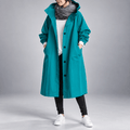 Oversized teal hooded trench coat in lightweight fabric with a single-breasted button front and deep slant hip pockets.