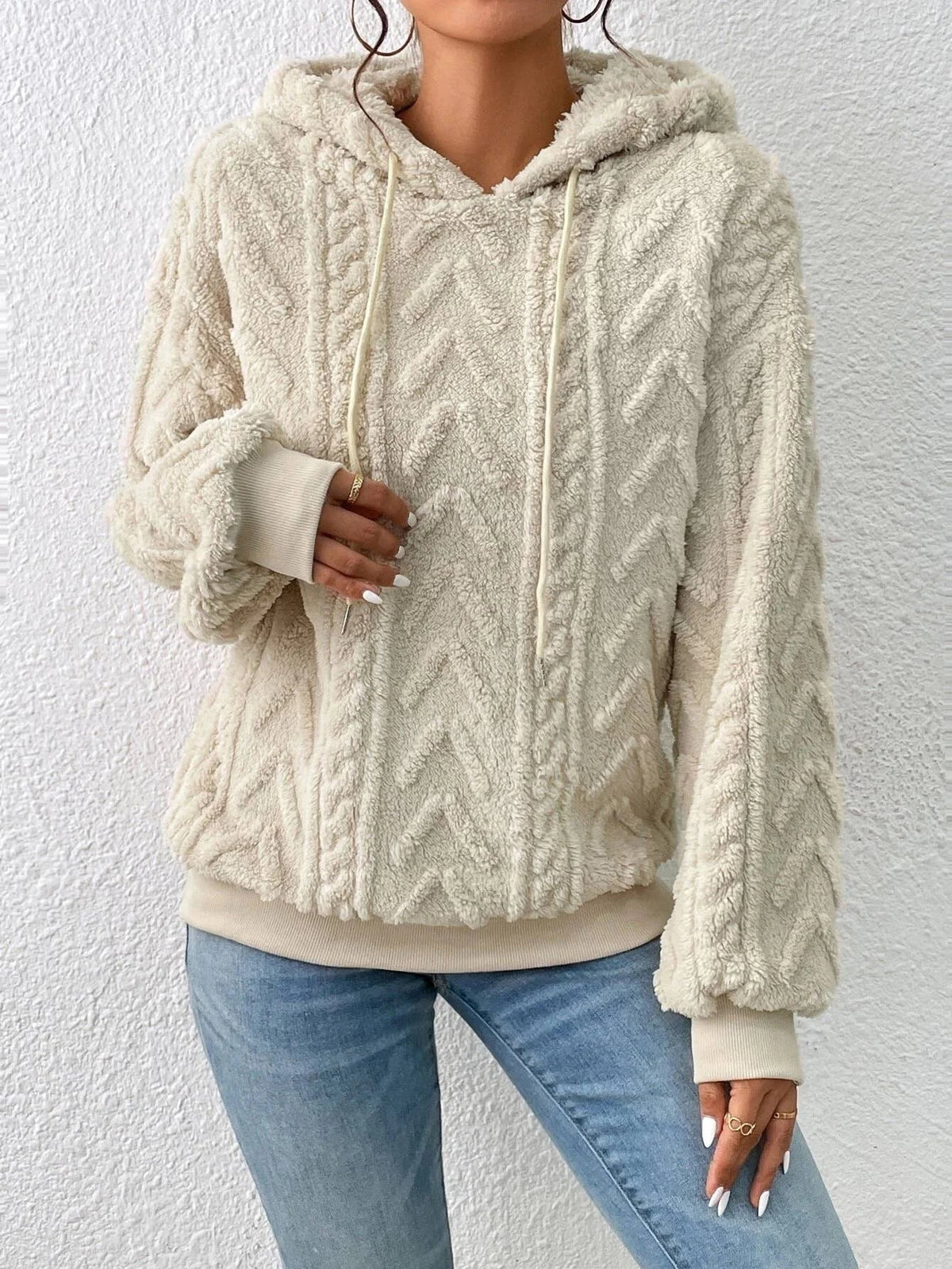 Oversized Plush Fleece Hoodie – Cream hoodie shown from the front on a female model with raised cable detailing