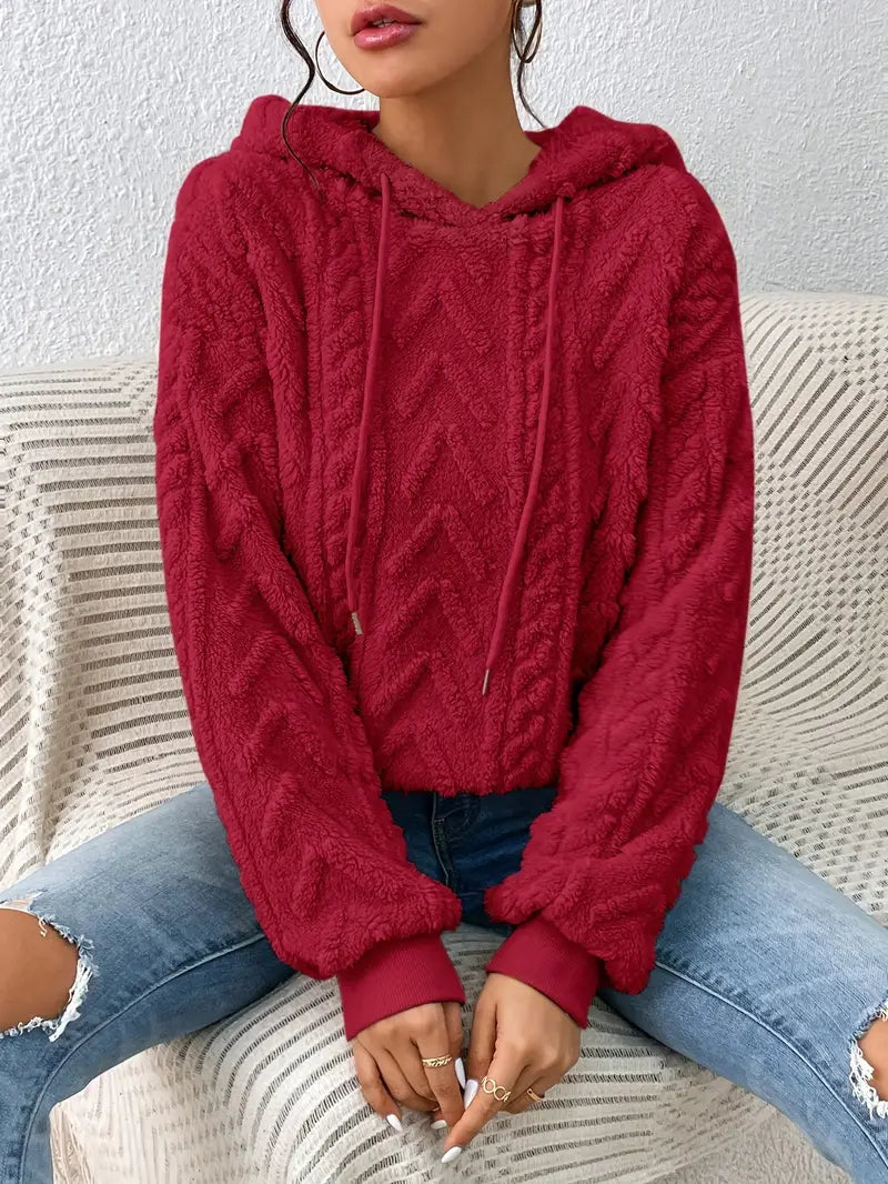 Oversized Plush Fleece Hoodie – Red hoodie worn by a female model with raised chevron cable pattern
