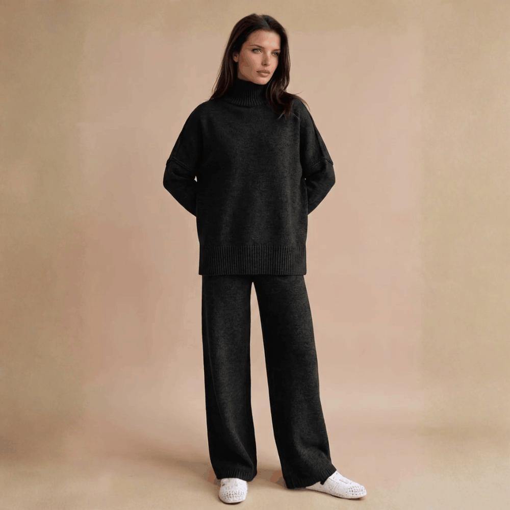 Full-length front view of a model wearing the oversized turtleneck ribbed knit lounge set in classic black.