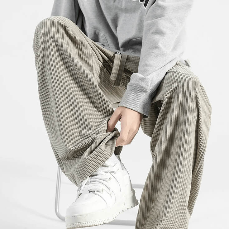 Light gray corduroy pants shown in a seated pose with side pockets