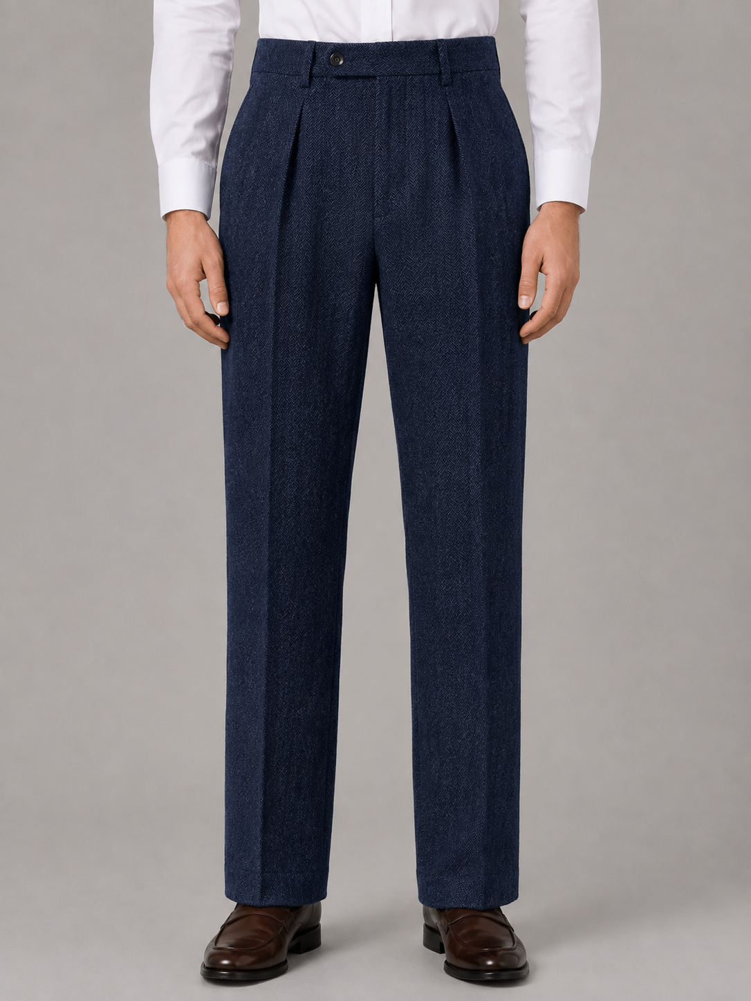 Navy blue herringbone trousers with a high-rise waist, front pleats, and a clean straight-leg silhouette.