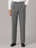 Gray herringbone pleated trousers in a high-rise, straight-leg cut with a tailored fit and side pockets.