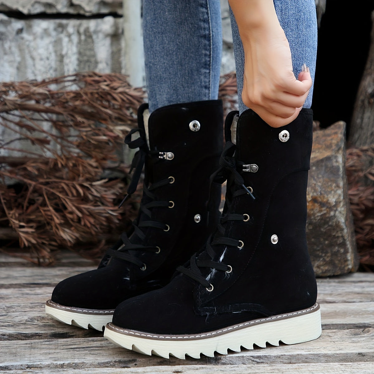 Black suede lace-up boots for women with the plush collar unfolded, showing the taller lace-up shaft