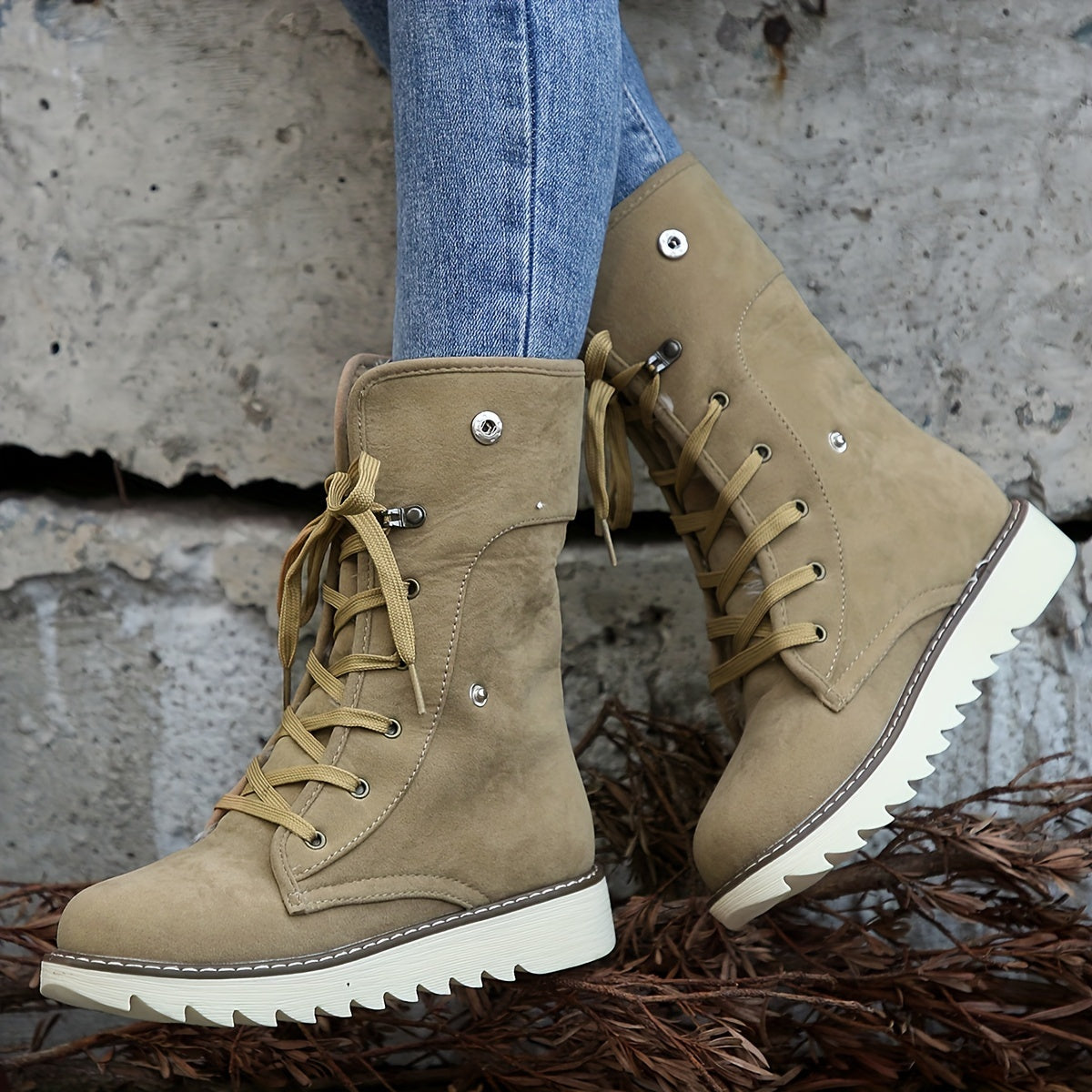 Taupe plush collar ankle boots for women with round laces through metal eyelets, worn with jeans