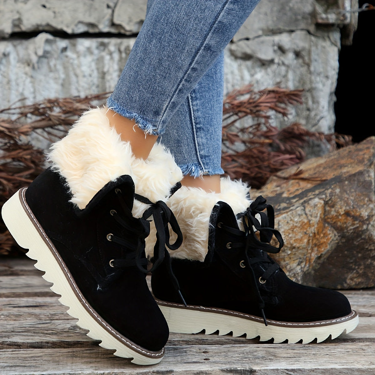 Black plush collar ankle boots for women with lace-up front and metal eyelets, worn with jeans