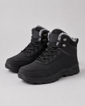 Black ankle boots with plush-lined collars, rugged lug soles, and metal lace-up speed hooks on a neutral background.
