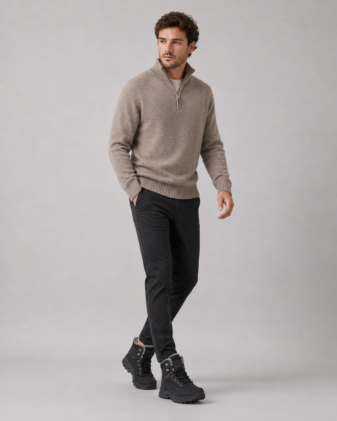 Black lace-up ankle boots with plush-lined collars and rugged lug soles worn with black trousers and a beige sweater.
