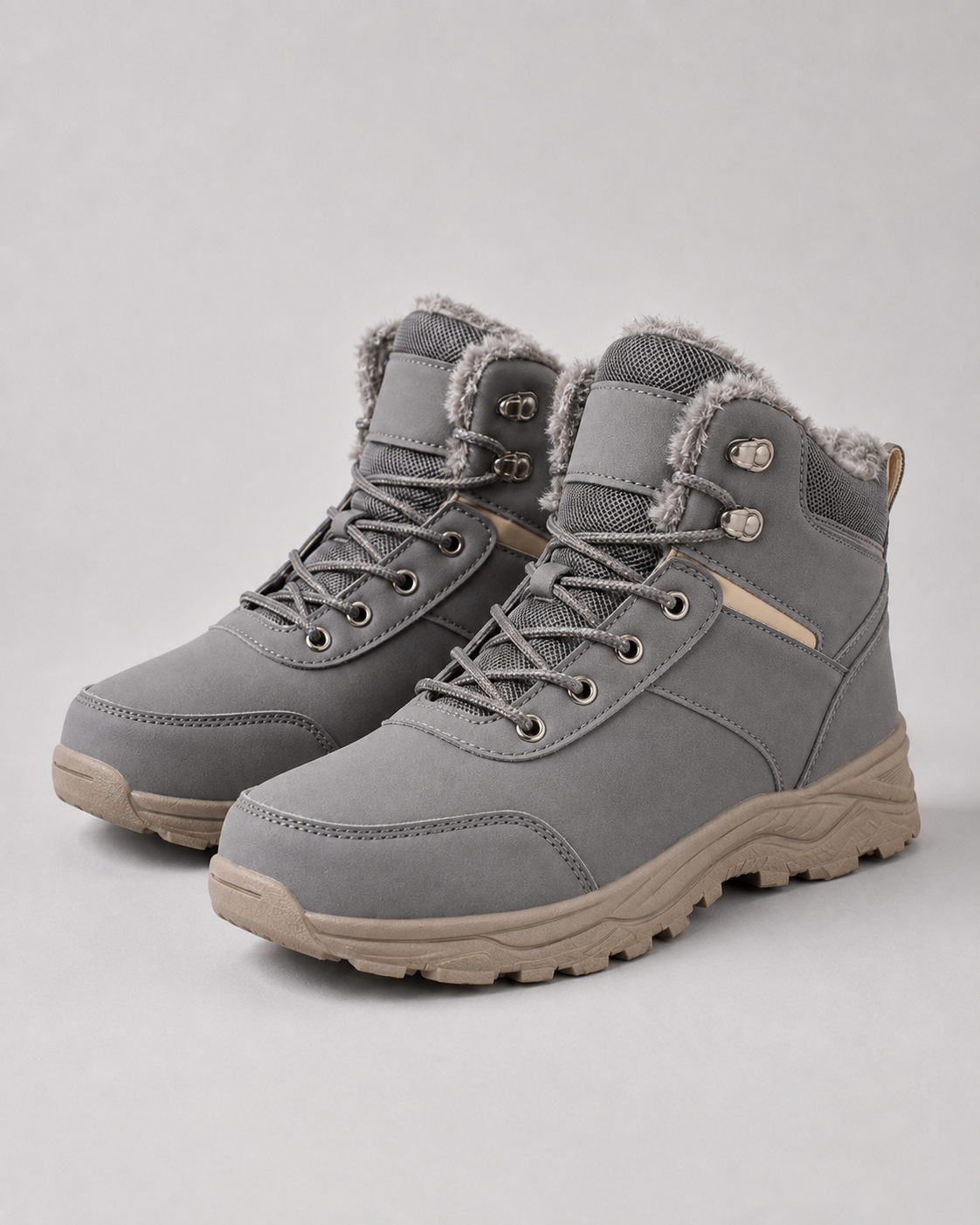 Grey ankle boots featuring a plush-lined collar, lace-up closure with speed hooks, and a rugged tan lug sole.