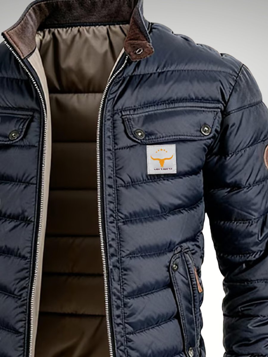 Navy  blue quilted puffer bomber jacket with a contrast brown stand collar, snap-flap chest pockets, and zip hip pockets.