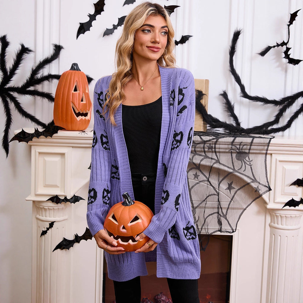 Model posing in the lavender purple open-front longline pumpkin cardigan, holding a small carved jack-o'-lantern prop