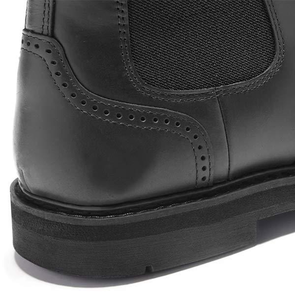 Close-up of the black boot heel, showing the stitched panel and rubber sole.