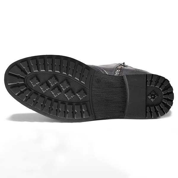 Bottom view of a black Chelsea boot showing the textured tread pattern.