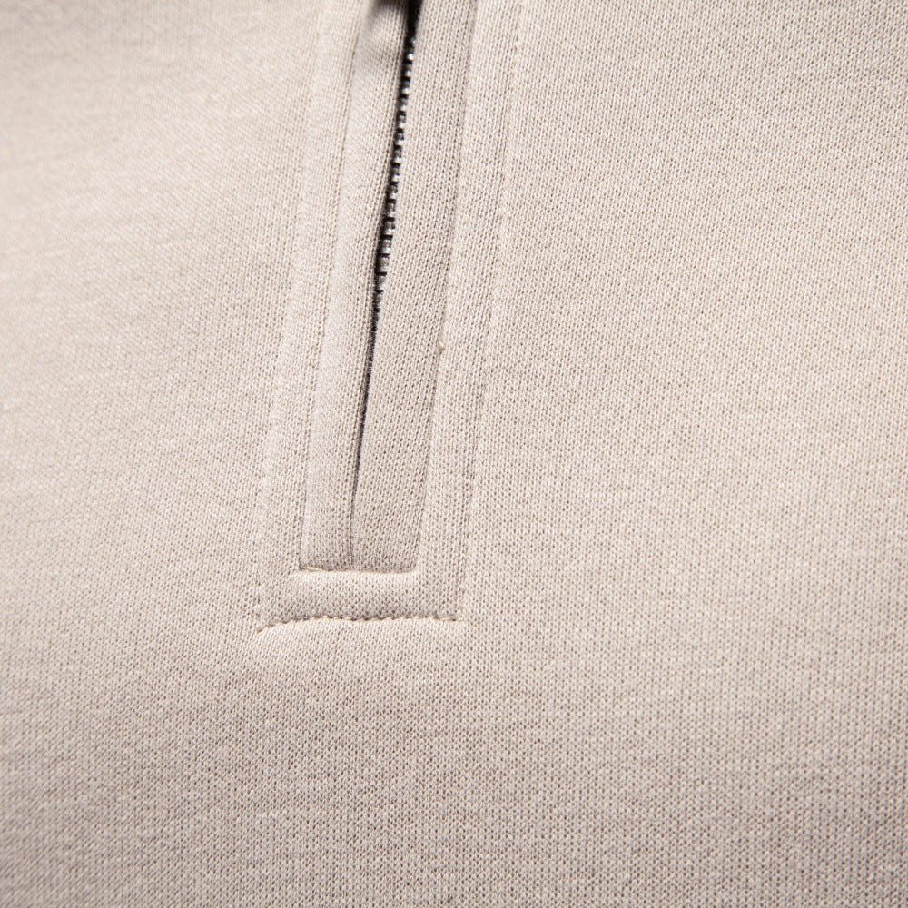 Close-up of the quarter-zip front zipper and textured fabric.