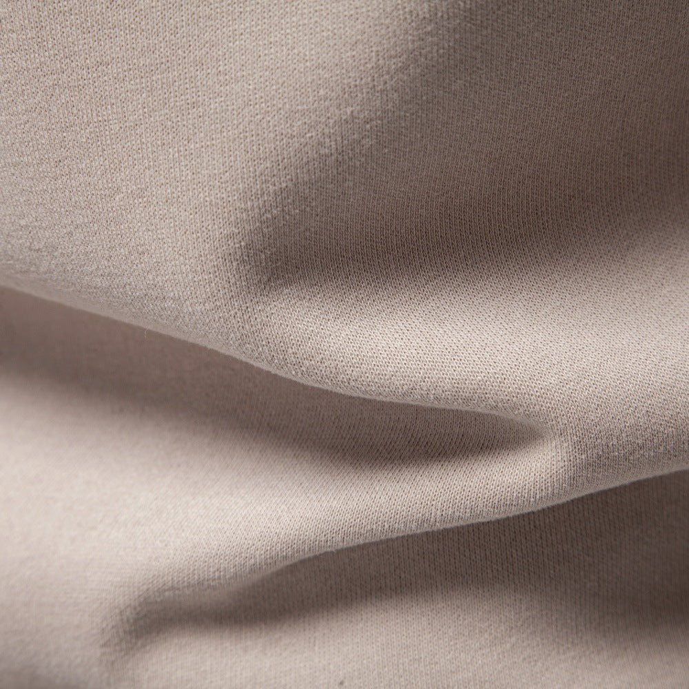 Close-up of the sweatshirt’s textured shoulder panel and raglan seam.