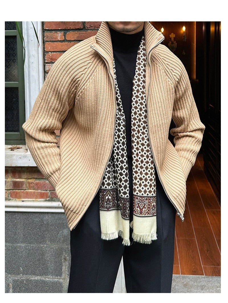 Beige rib-knit linen-blend cardigan with a zip front, high collar, and relaxed fit layered over a black turtleneck.