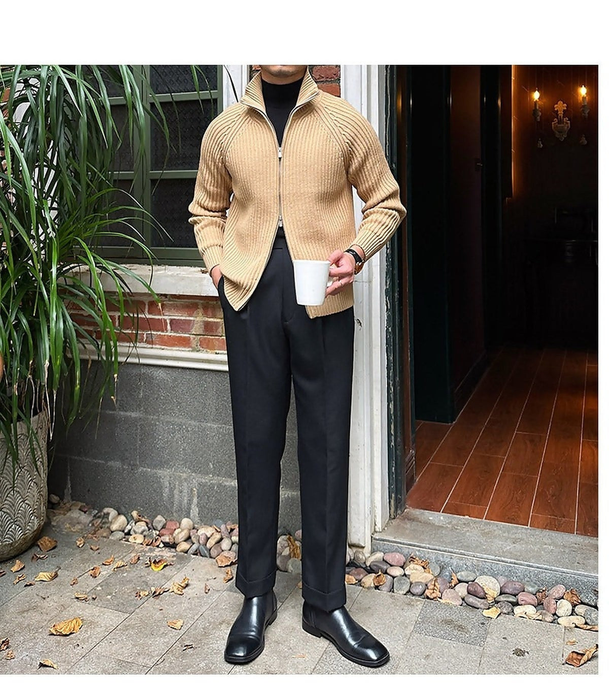Relaxed-fit beige linen-blend knit cardigan with a full-zip front, ribbed trim, and structured collar worn over a black turtleneck.