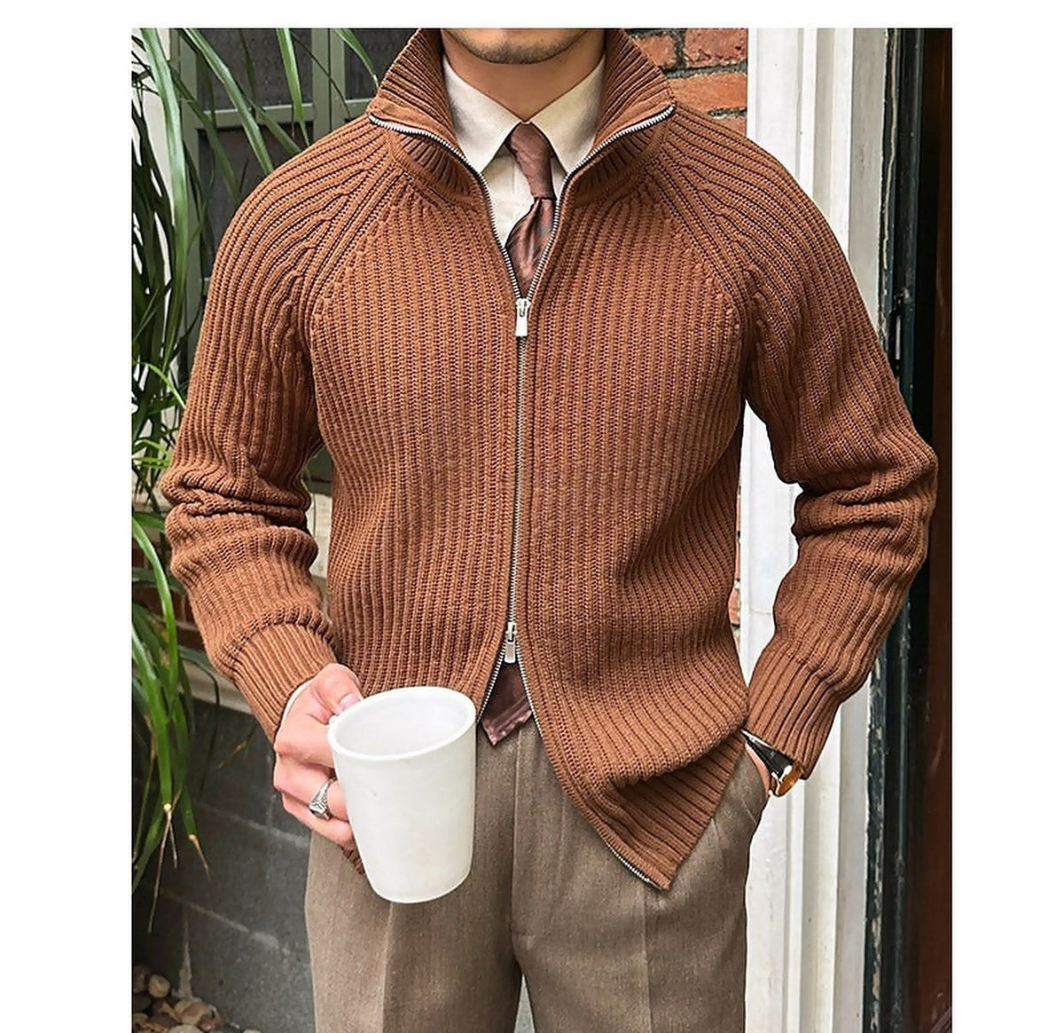Brown linen-blend knit cardigan with a ribbed zip-up collar, worn over a collared shirt and tie.
