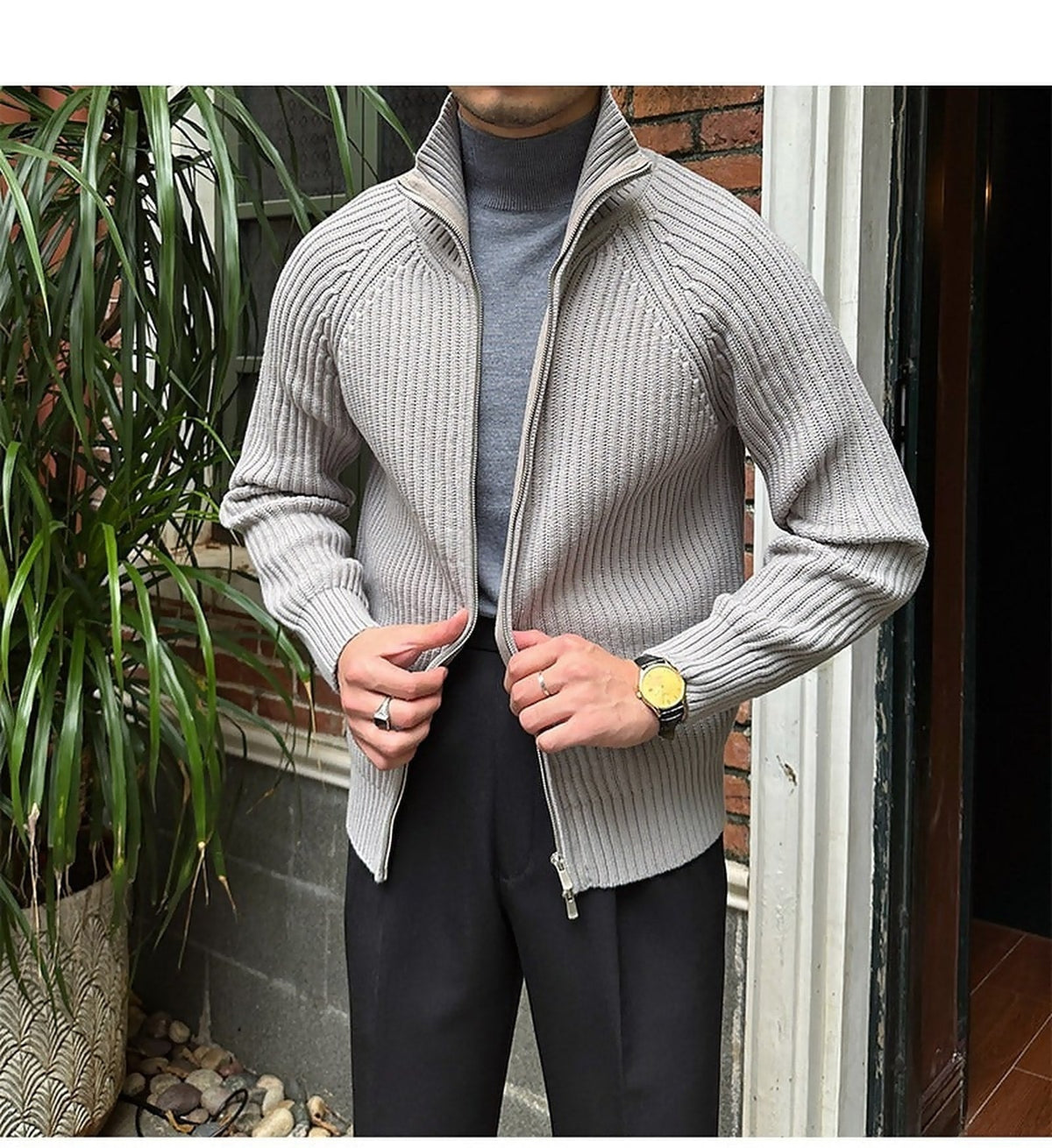 Light gray ribbed knit cardigan in a relaxed linen-blend, featuring a full-zip front and structured collar over a turtleneck.
