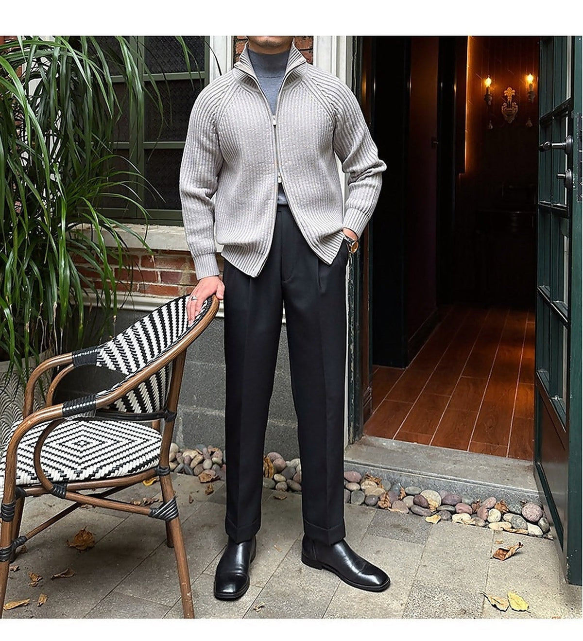 Ligtht gray ribbed knit zip-up cardigan in a relaxed linen-blend, styled with a mock-neck top and tailored black trousers.