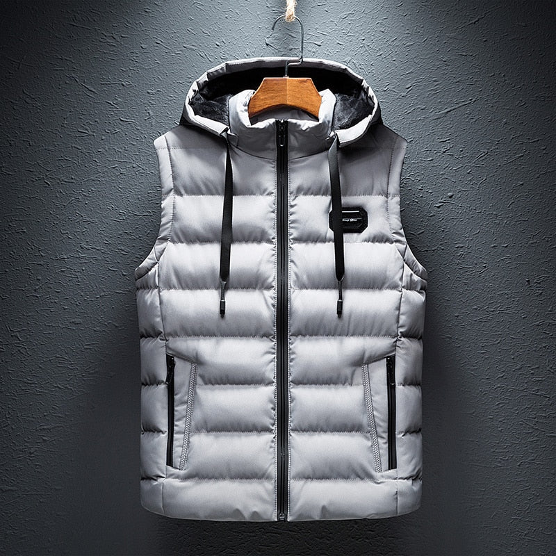 Front product hanging view of the reversible hooded channel-quilted puffer vest in light gray with black contrast trim.