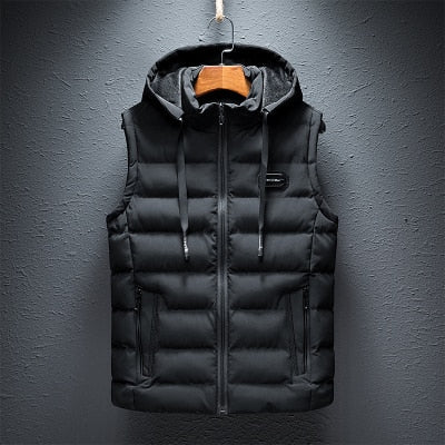 Full front product hanging display of a classic black reversible hooded puffer vest featuring horizontal channel quilting, a full-zip front closure, chest rubber logo patch, and drawstring hood.
