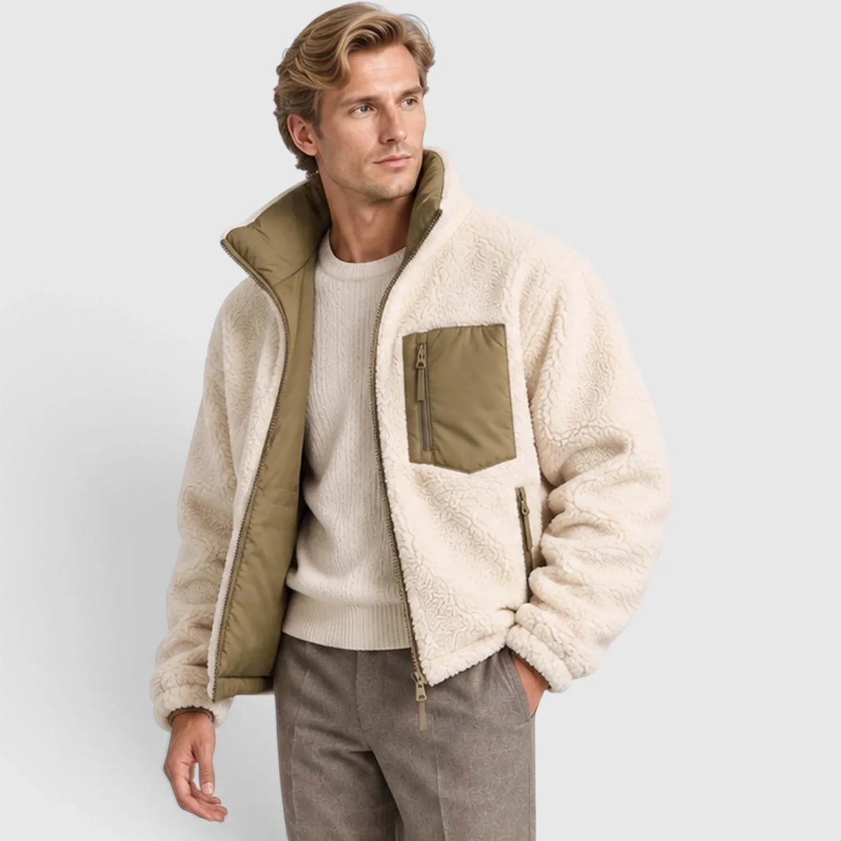 Reversible cream fleece puffer jacket with olive green accents, stand collar, and zip-front closure on a male model.