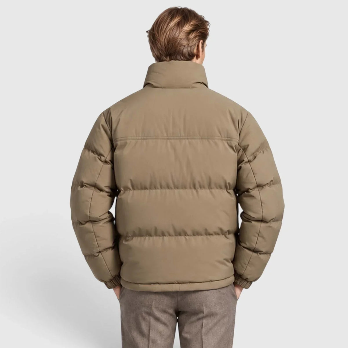 Khaki reversible puffer jacket with wide channel quilting, stand collar, and rib-knit cuffs, shown from the back.