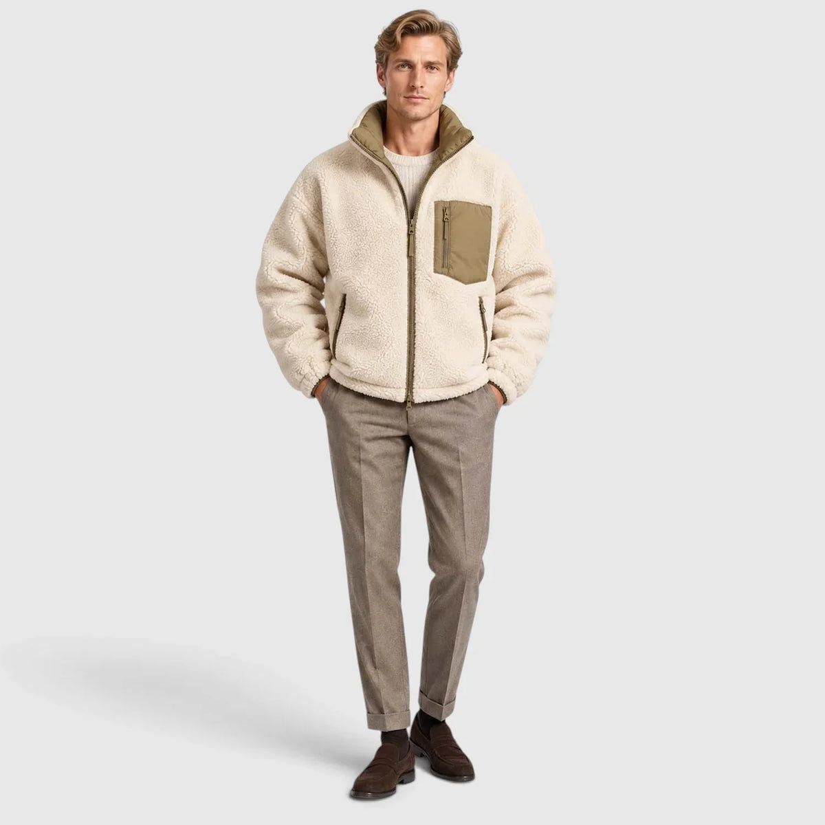 Reversible cream sherpa puffer jacket with olive trim, stand collar, zip chest pocket, and rib-knit cuffs on a man.