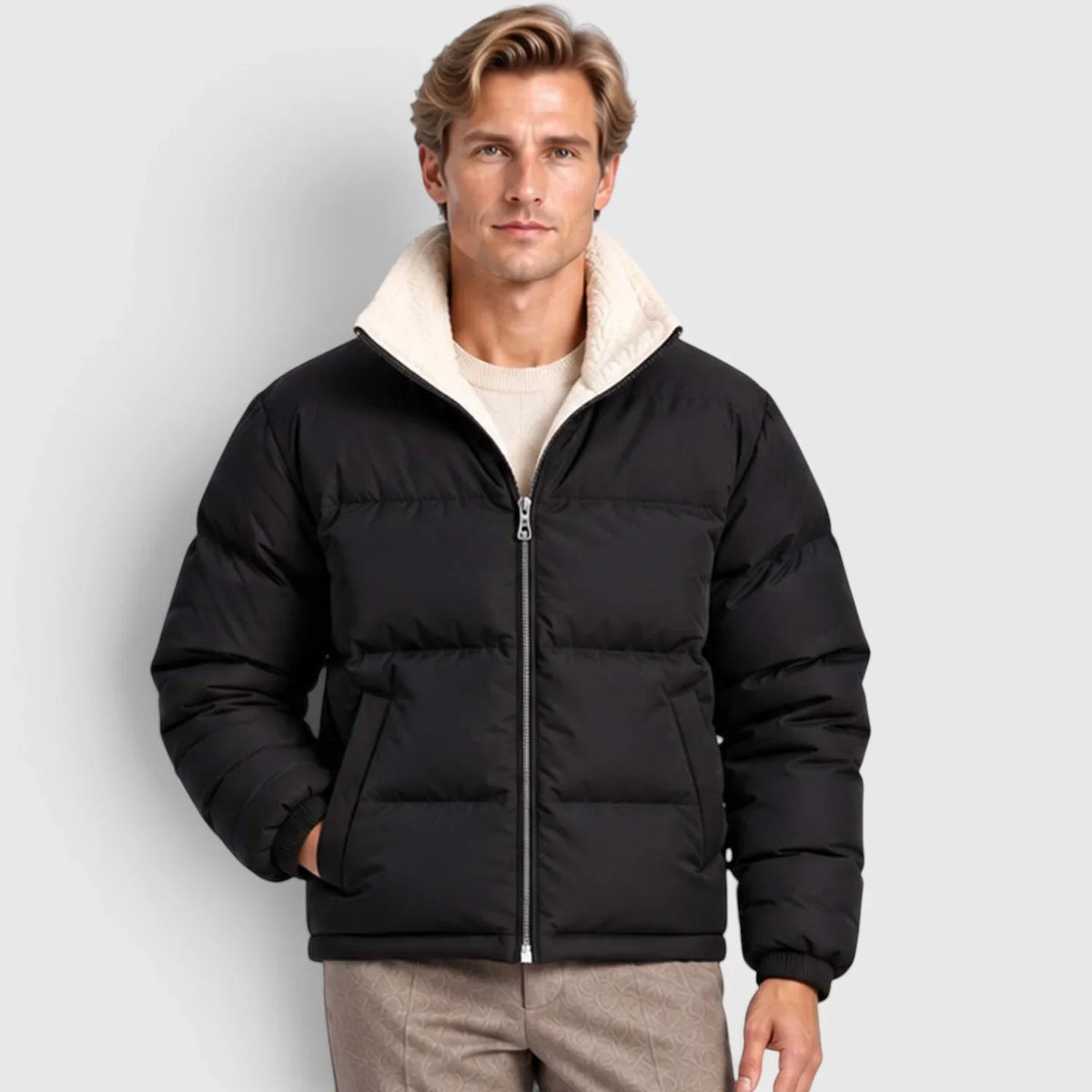 Black reversible puffer jacket with wide channel quilting, plush cream stand collar, and rib-knit cuffs on a male model.