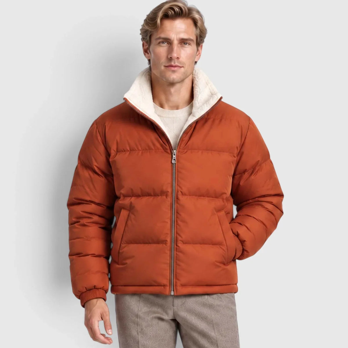 Rust orange reversible puffer jacket with wide channel quilting, plush cream stand collar, and rib-knit cuffs.
