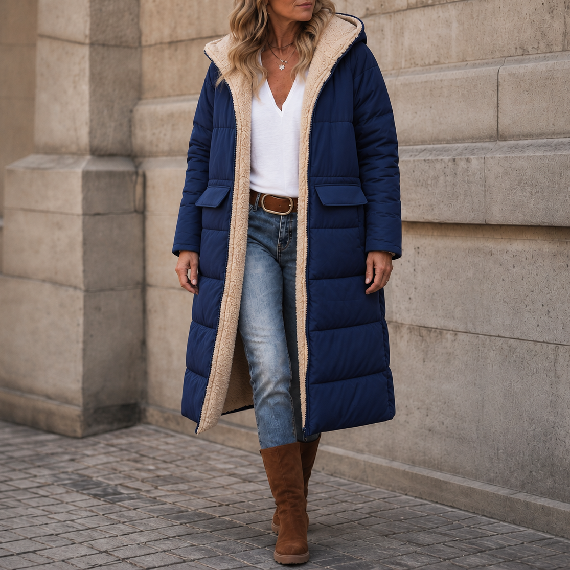 Navy blue longline puffer coat with a plush cream sherpa lining, built-in hood, and flap pockets in a relaxed fit.