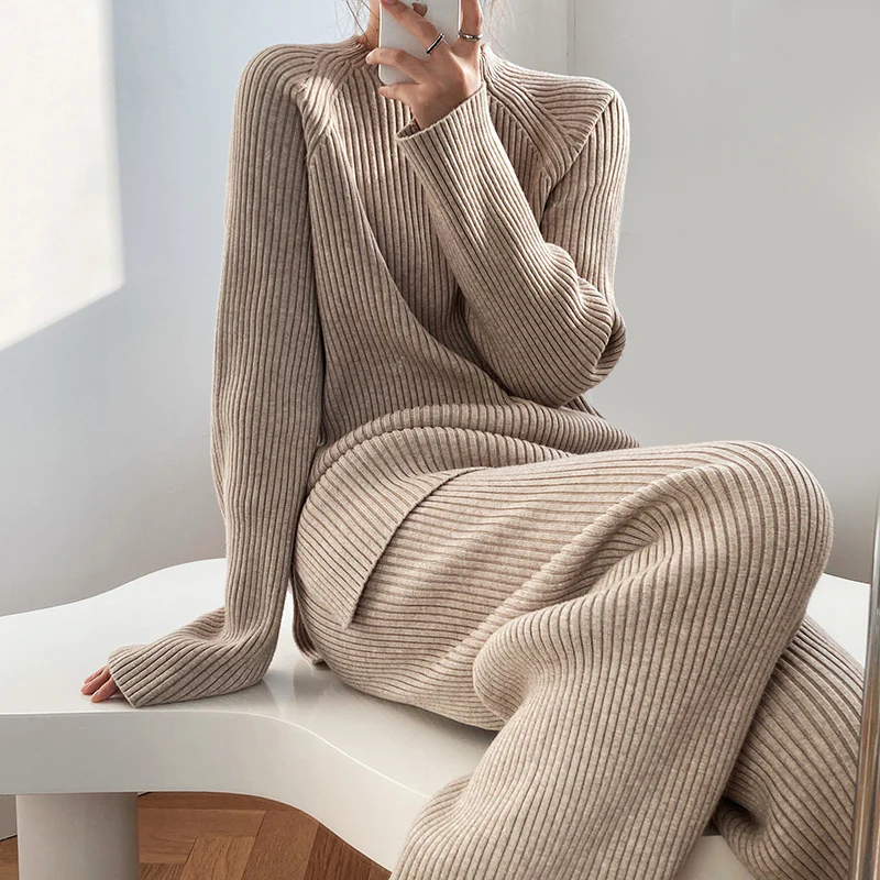 Close-up seated view of a model wearing the taupe beige ribbed knit lounge set, highlighting the mock neckline and textured knit fabric.