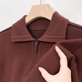 Close-up of the brown quarter-zip polo showing the ribbed knit texture and collar.