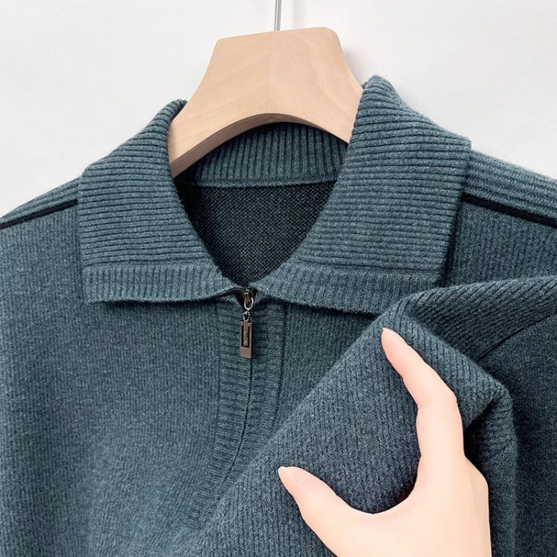 Blue-gray ribbed knit quarter-zip polo shown on a hanger.