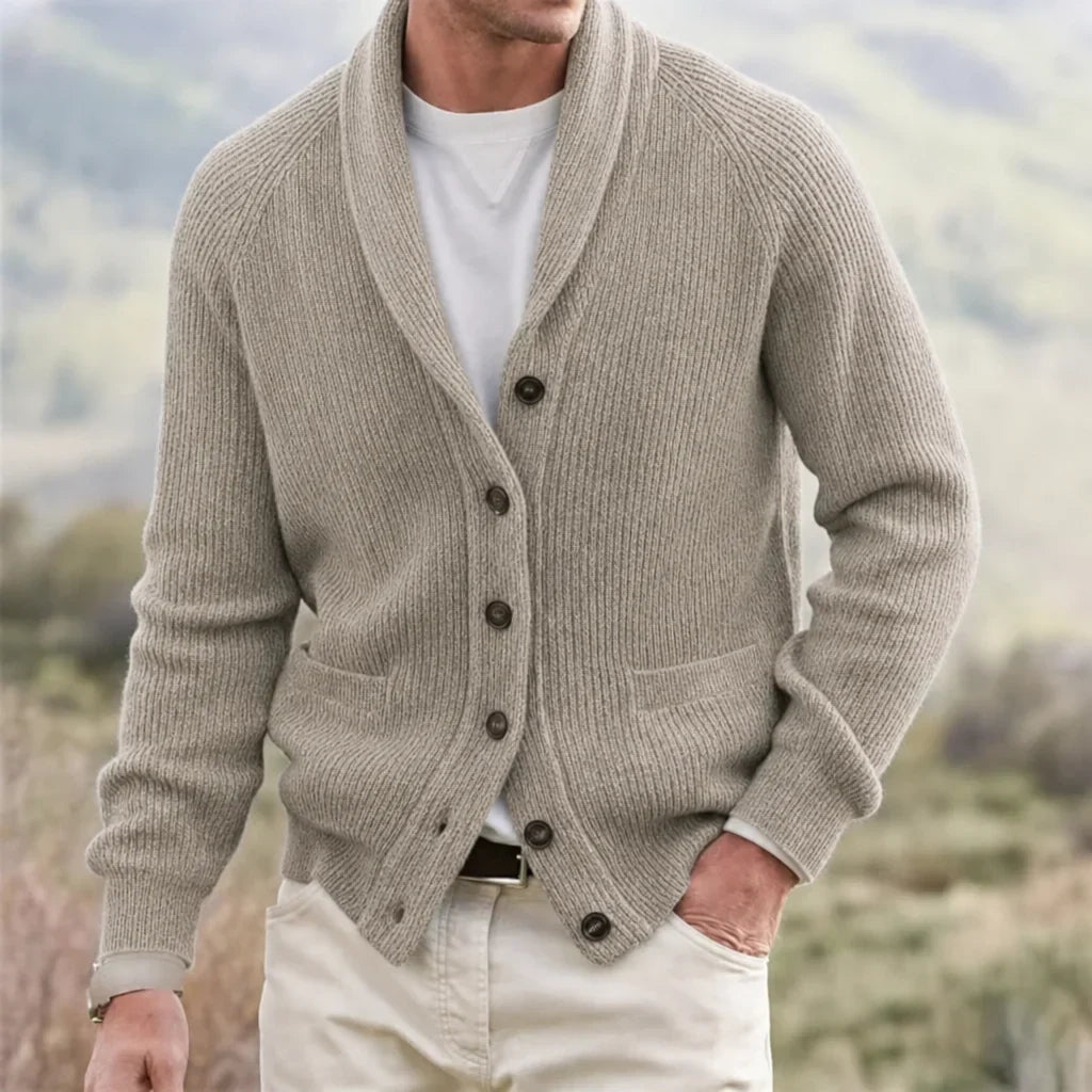 Beige ribbed knit shawl collar cardigan with raglan sleeves, button front, and front pockets worn over a white tee.