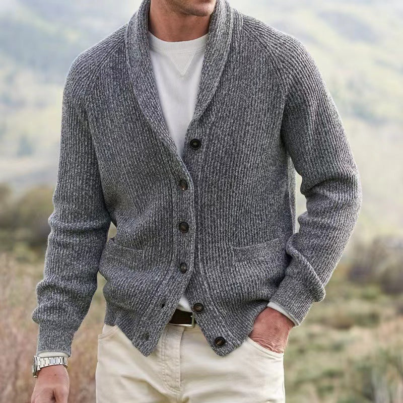 Gray ribbed knit shawl collar cardigan with raglan sleeves, button front, and front pockets worn over a white shirt.