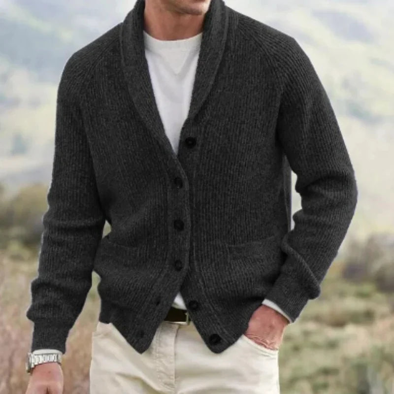 Black ribbed knit cardigan with a shawl collar, raglan sleeves, and front pockets worn over a white t-shirt.