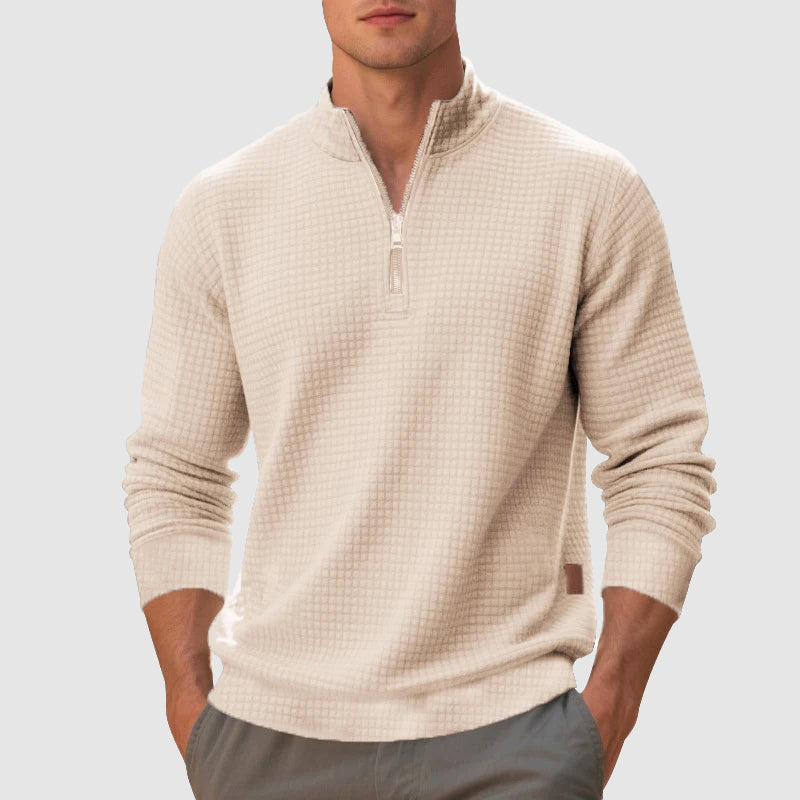 Beige waffle knit quarter zip pullover with a stand collar and ribbed cuffs worn in a trim, regular fit.