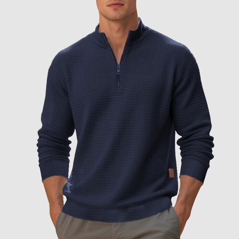 Navy blue waffle knit quarter zip pullover with a stand collar, ribbed cuffs, and a trim, mid-weight fit.
