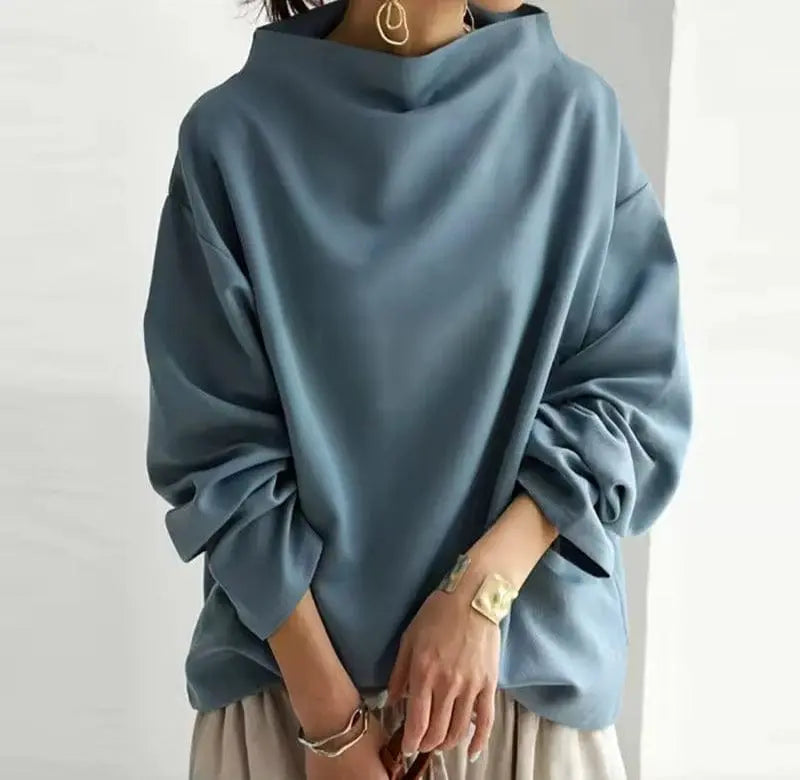 Dusty blue oversized mock neck sweatshirt with dropped shoulders and long sleeves, styled with a relaxed everyday fit.