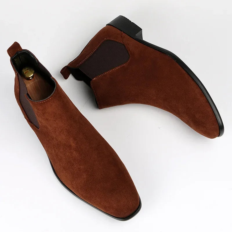 Brown suede Chelsea boots with a modern square toe, elastic side panels, and a sturdy low block heel.