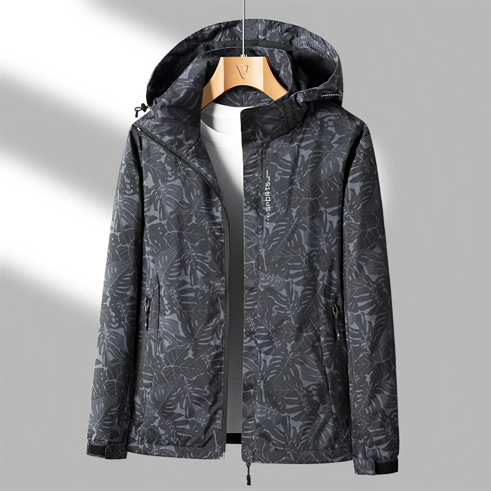 Black hooded waterproof jacket featuring a full-zip closure, adjustable hood, zippered pockets, and long sleeves on a white background.