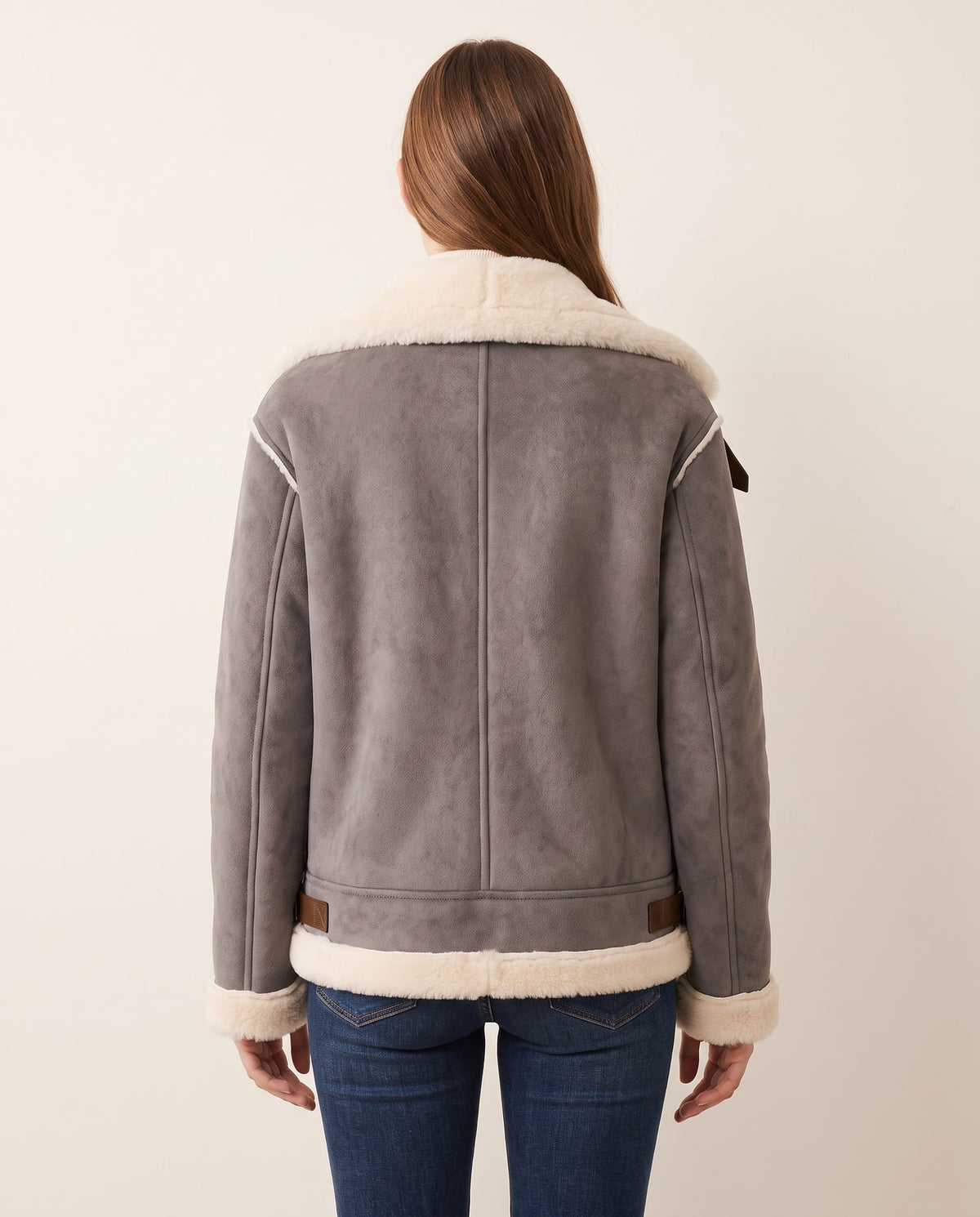 Gray shearling aviator jacket with a plush cream collar, trimmed cuffs, and structured back seams.