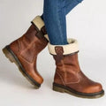 Brown vegan leather mid-calf boots for women with cream shearling-look cuff folded down, worn with jeans