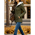 Olive green Sherpa-Lined Hooded Parka worn by a female model, featuring a snap placket, flap pockets, drawstring hood, curved hem, and fitted silhouette.