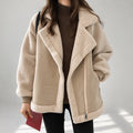 A woman wearing a cream sherpa suede aviator jacket with an oversized lapel, plush lining, and zip front